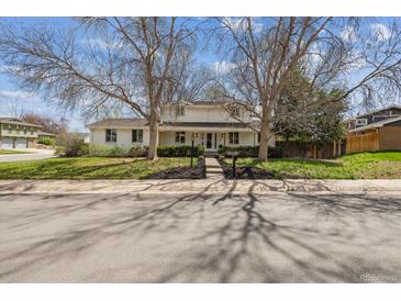 Charming two-story home with mature trees and well-manicured front yard, perfect curb appeal at 3756 S Chase St, Denver, CO 80235