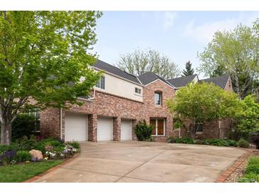 Charming brick home with a three-car garage and mature trees, offering curb appeal and convenience at 6274 S Iola Ct, Englewood, CO 80111