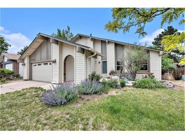 Charming home with landscaped front yard, inviting entryway, and attached garage at 3756 S Mission Pkwy, Aurora, CO 80013