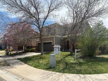 Inviting two-story home featuring a two-car garage and well-maintained landscaping at 14944 E Archer Cir, Aurora, CO 80012