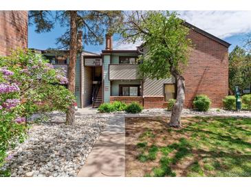A charming two-story condo with well-maintained landscaping is surrounded by lush foliage at 11905 E Harvard Ave # 208, Aurora, CO 80014