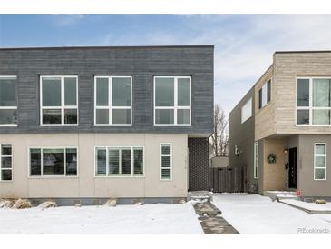 Modern two-unit building with gray and wood siding, snowy landscape at 1576 W Maple Ave, Denver, CO 80223