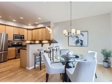 Bright kitchen featuring stainless steel appliances, light wood cabinets, and an adjacent dining area at 4137 Clifton Ct, Boulder, CO 80301