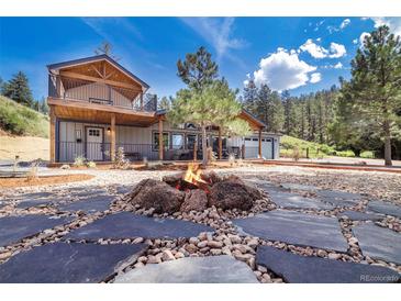 Inviting home featuring an outdoor fire pit and a charming two-story design with a balcony at 2230 S Platte River Rd, Sedalia, CO 80135