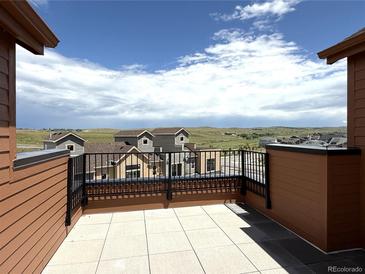 Enjoy this outdoor patio with tile floors and mountain view at 9627 Browns Peak Cir, Littleton, CO 80125