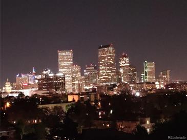 Night panoramic view of Denver skyline featuring illuminated buildings and vibrant city lights at 1085 N Lafayette St # 704, Denver, CO 80218