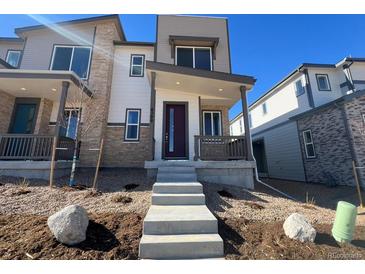 Charming new build with a modern design, landscaped front yard and inviting entryway at 6599 N Netherland St, Aurora, CO 80019