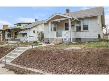 Charming home featuring a covered front porch and a well-maintained yard at 3226 S Grant St, Englewood, CO 80113