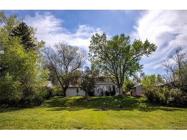 Charming home nestled among mature trees, set back on a well manicured lawn, creating a peaceful and private setting at 4667 Ashfield Dr, Boulder, CO 80301