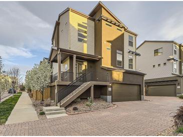 Contemporary home featuring mixed siding, a brick driveway, and an attached garage, steps, and a garden at 2564 Sweet Wind Ave, Castle Rock, CO 80109