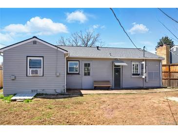 View of a charming backyard with a bench and access to the home's entrance at 764 S Osage St, Denver, CO 80223