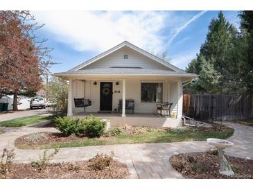 Charming single-story home with a covered front porch, swing, and landscaped front yard at 6192 S Pennsylvania St, Centennial, CO 80121