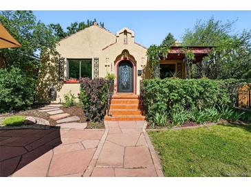 Charming home featuring a beautifully landscaped front yard and eye-catching front entrance with tile steps at 1332 Ash St, Denver, CO 80220