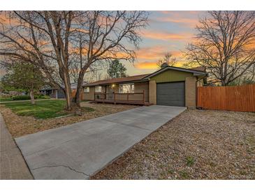 Charming single-story home with a spacious driveway and a cozy front porch, perfect for enjoying the sunset at 482 W Caley Ave, Littleton, CO 80120