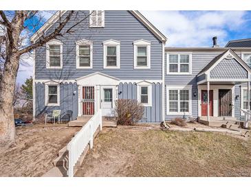 Charming two-story townhouse with blue siding, white trim, well-maintained landscape, and a welcoming front entrance at 2280 S Jasper Way # B, Aurora, CO 80013