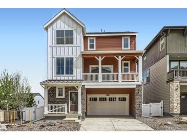 Attractive home with a blend of stone, wood and siding, an attached two car garage and welcoming front porch at 2094 S Haleyville Way, Aurora, CO 80018