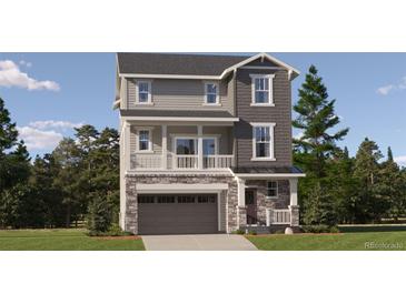 Two-story gray home with stone accents, a covered porch, and an attached two-car garage at 2094 S Haleyville Way, Aurora, CO 80018