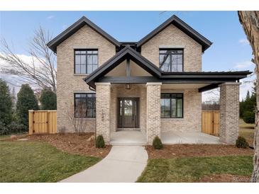 Stunning new construction featuring brick facade and covered porch on professionally landscaped lot at 1149 S Madison St, Denver, CO 80210