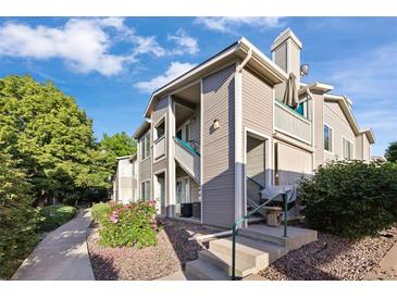 Attractive condo showcasing well-maintained siding, entry stairs, landscaping, and charming curb appeal at 3857 Mossy Rock Dr # 201, Highlands Ranch, CO 80126