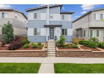 Charming two-story home featuring tasteful landscaping and a welcoming front entrance, perfect for curb appeal at 9682 Dunning Cir, Highlands Ranch, CO 80126