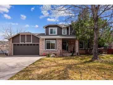 Charming two-story home showcasing a well-manicured lawn and a two-car garage at 4 Mountain Ash, Littleton, CO 80127