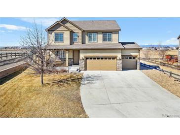 Two-story home featuring a spacious three-car garage, large driveway and covered porch at 16525 Sanford St, Mead, CO 80542