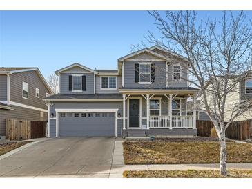 Charming two-story home featuring a welcoming front porch and well-maintained landscaping at 441 Baler Ct, Brighton, CO 80601