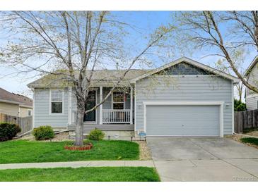 Charming single-story home with a well-manicured lawn, covered porch, and attached two-car garage at 4312 Windmill Dr, Brighton, CO 80601