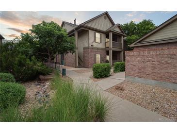 Inviting exterior of a two-story home with a combination of brick and siding, a welcoming entry, and manicured landscaping at 23376 E 5Th Pl # 201, Aurora, CO 80018