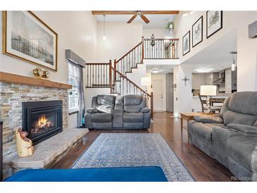 Spacious living room features a fireplace and hardwood floors at 961 S Evanston Cir, Aurora, CO 80012