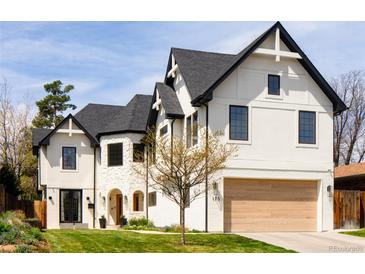 Stunning home featuring a modern Tudor design with a black roof, white brick, and a spacious two-car garage at 175 S Jasmine St, Denver, CO 80224