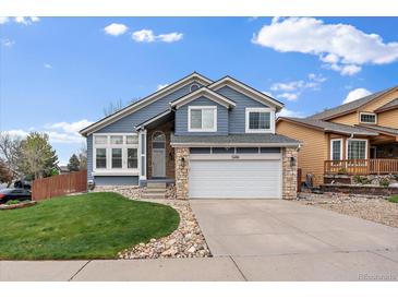 Charming two-story home with a well-manicured lawn and a two-car garage at 5486 S Cathay Way, Centennial, CO 80015