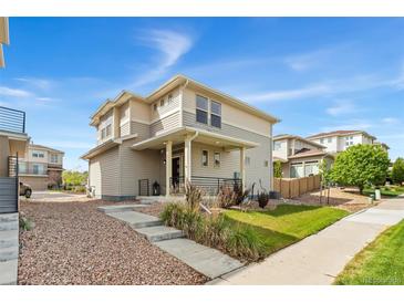 Two-story home with neutral siding, a covered front porch, and a well-maintained front yard at 3692 Celestial Ave, Castle Rock, CO 80109