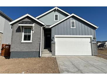 Charming home with a combination of brick and siding, complemented by a two-car garage and well-lit exterior at 3342 N Buchanan Way, Aurora, CO 80019