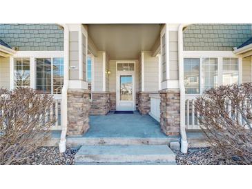 Charming front porch with stone accents, offering a welcoming entrance to the home at 16047 E Geddes Ln # 128, Aurora, CO 80016