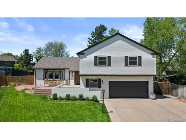 Charming two-story home with manicured lawn, white siding, and updated landscaping at 7633 S Gilpin Ct, Centennial, CO 80122