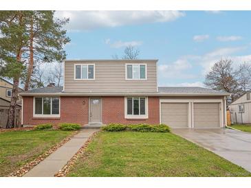 Charming two-story home with a well-manicured lawn and a two-car garage at 4623 S Kalispell Way, Aurora, CO 80015