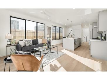 Bright living room features modern decor, large windows, and an open floor plan at 263 S Jackson St, Denver, CO 80209
