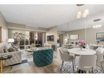 Bright living room featuring a large balcony, modern furniture, and an open floor plan at 1121 Albion St # 305, Denver, CO 80220