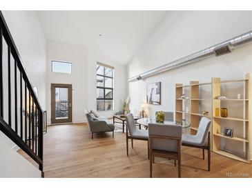 Bright, open living room features modern decor, wood floors, and lots of natural light at 3195 Blake St # 201, Denver, CO 80205