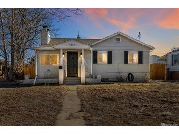 Charming single-story home featuring a well-maintained front yard and traditional architectural details at 1812 S Hazel Ct, Denver, CO 80219