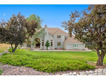 Brick home with landscaped yard and a three-car garage at 13 Red Fox Ln, Littleton, CO 80127