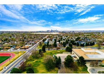 Distant skyline view from an aerial shot that overlooks a greenbelt area with city access at 7080 W 20Th Ave # 202, Lakewood, CO 80214