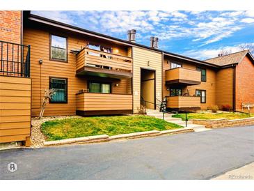 Exterior shot of townhome featuring balconies and front lawn at 7080 W 20Th Ave # 202, Lakewood, CO 80214