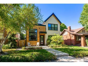 Charming two-story home featuring modern wood and brick accents with a well-manicured front yard at 619 S High St, Denver, CO 80209