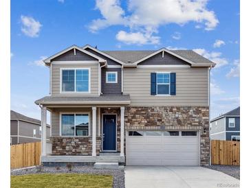 Charming two-story home with stone accents, a covered porch and a two-car garage at 6519 14Th St, Frederick, CO 80530