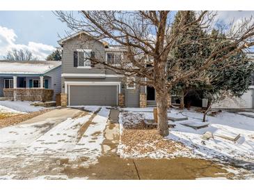 Charming two-story gray home featuring an attached two-car garage and a well-maintained front yard at 364 Willowick Cir, Highlands Ranch, CO 80129