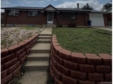 Charming red brick ranch-style home with a well-maintained lawn and inviting front entrance at 8278 Cherokee St, Denver, CO 80221