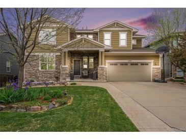 Beautiful two-story home with stone accents, a landscaped yard, and a charming front porch at 2349 Hickory Pl, Erie, CO 80516