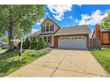 Charming two-story home boasts a well-manicured lawn and an attached two-car garage, perfect for a Gathering at 13270 W 65Th Ave, Arvada, CO 80004